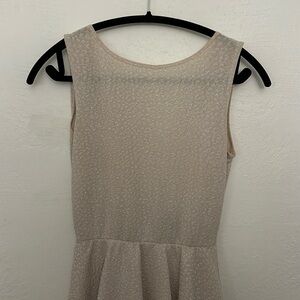 This is a beige mini backless dress. It is sparkly and is from Windsor.